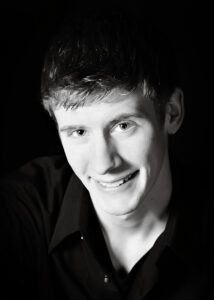 Smiling young man in black and white.